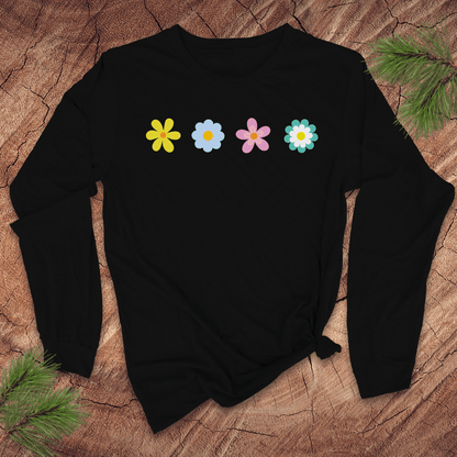 black  long-sleeve shirt with colorful flower designs on a wooden surface with pine branches