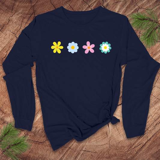 Navy blue long-sleeve shirt with colorful flower designs on a wooden surface with pine branches
