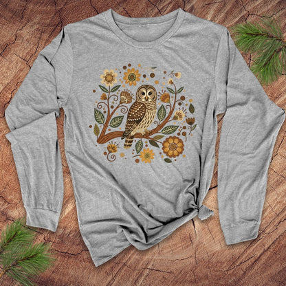 Gray long-sleeve shirt with an owl and floral design on a wooden surface