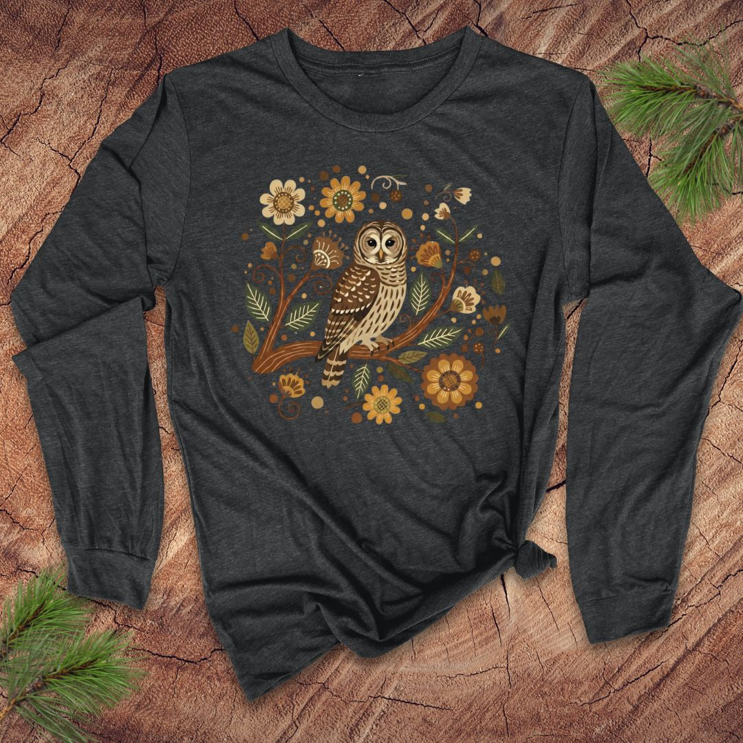 Dark gray long-sleeve shirt with an owl and floral design on a wooden surface.