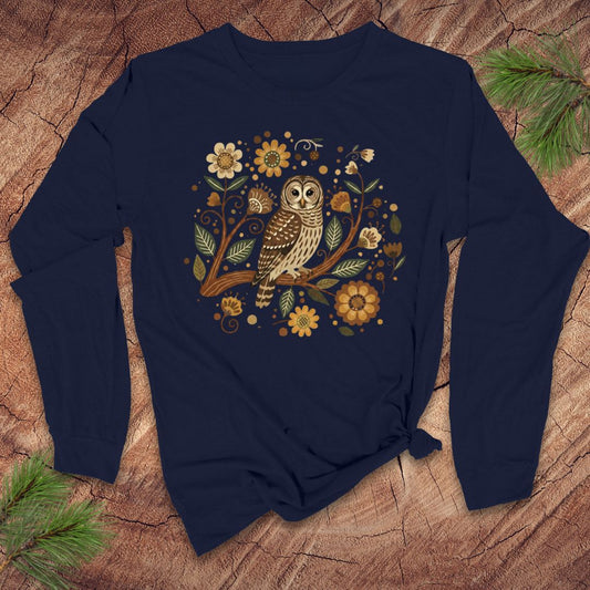 Navy blue long-sleeve shirt with an owl and floral design on a wooden surface.