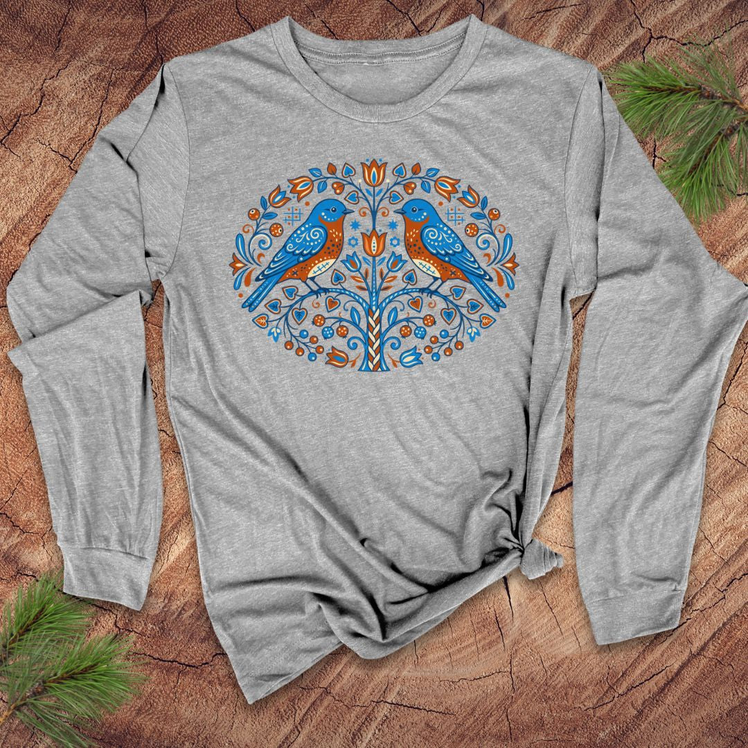 Gray long-sleeve shirt with a decorative design of two blue birds on a wooden surface.