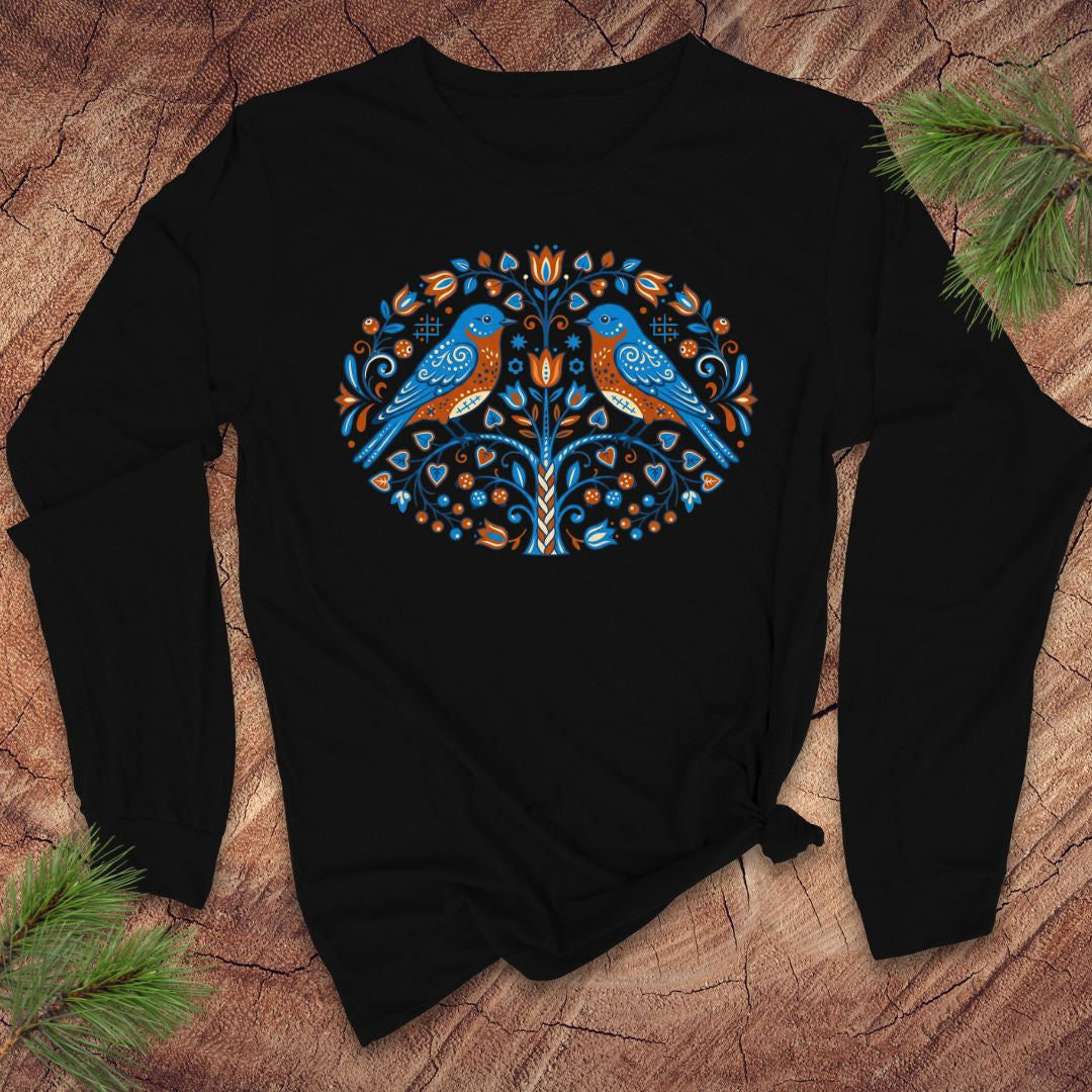 Black long-sleeve tshirt with blue bird design on a wooden surface