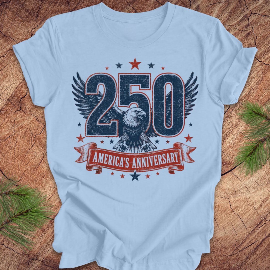 Light blue t-shirt with '250 America's Anniversary' design featuring an eagle on a wooden surface.