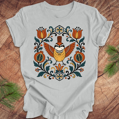Gray t-shirt with a carolina wren and floral design on a wooden surface