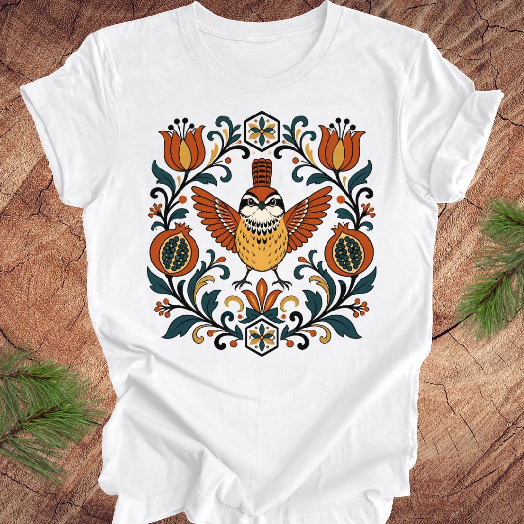 White t-shirt with a carolina wren and floral design on a wooden surface
