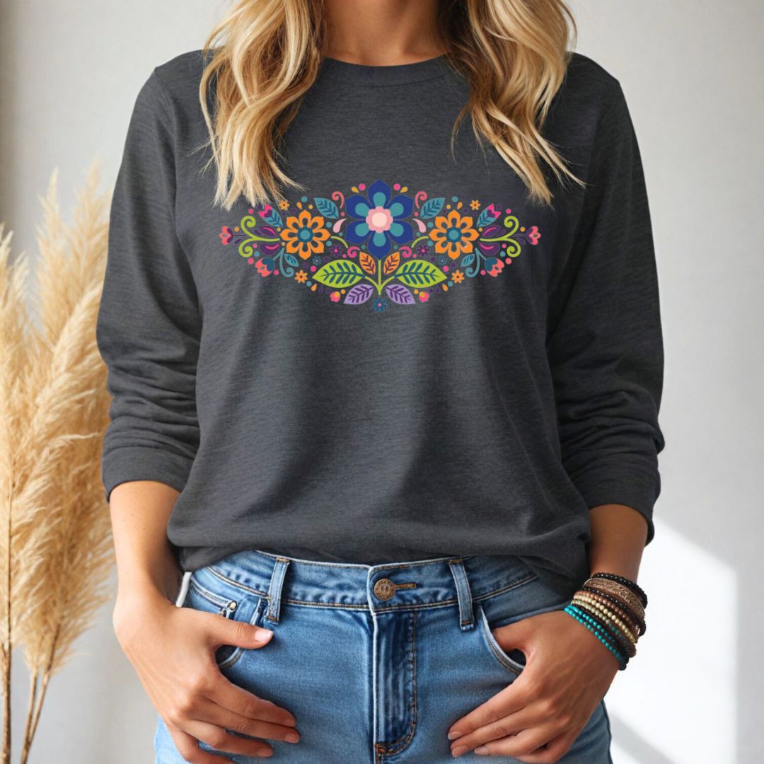 Person wearing a dark gray long-sleeve tshirt with a colorful floral design, standing against a neutral background.