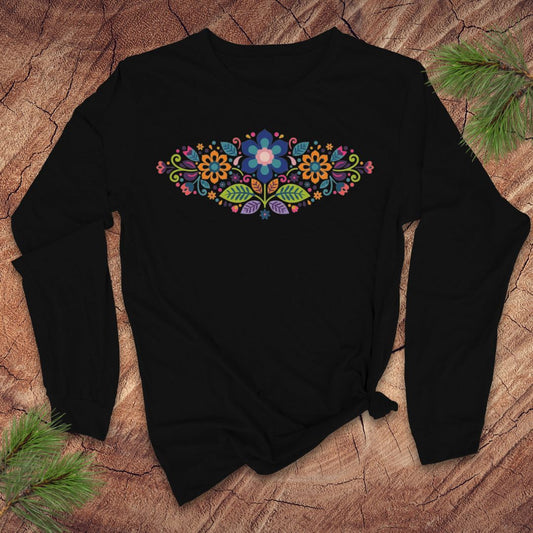 Black long-sleeve t-shirt with a vibrant floral pattern in an oval shape, on a wooden background.