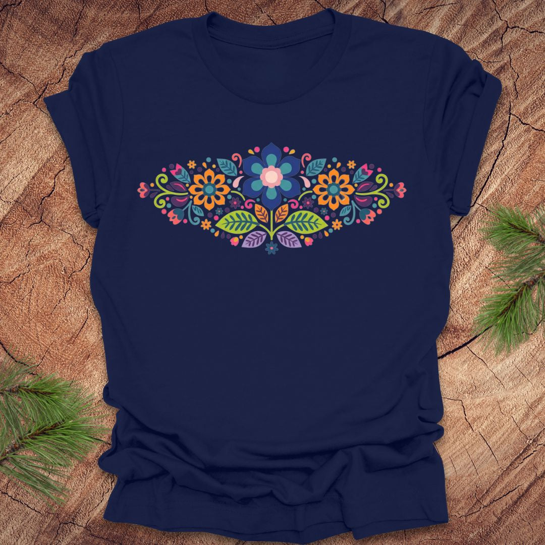 Navy blue t-shirt with a vibrant floral pattern in an oval shape, on a wooden background.