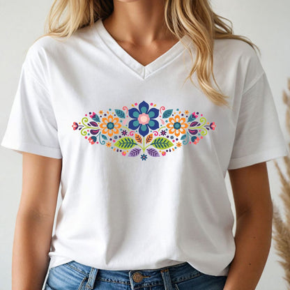 White t-shirt with colorful folk art floral design worn by a person