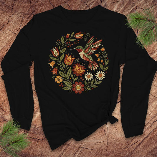 Black long-sleeve tshirt with a colorful hummingbird and floral design on a textured surface.