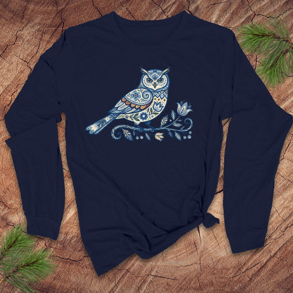 Navy blue long-sleeve shirt with a blue folk art floral owl design on a wooden surface.