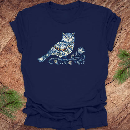 Navy blue t-shirt with a blue folk art floral owl design on a wooden surface
