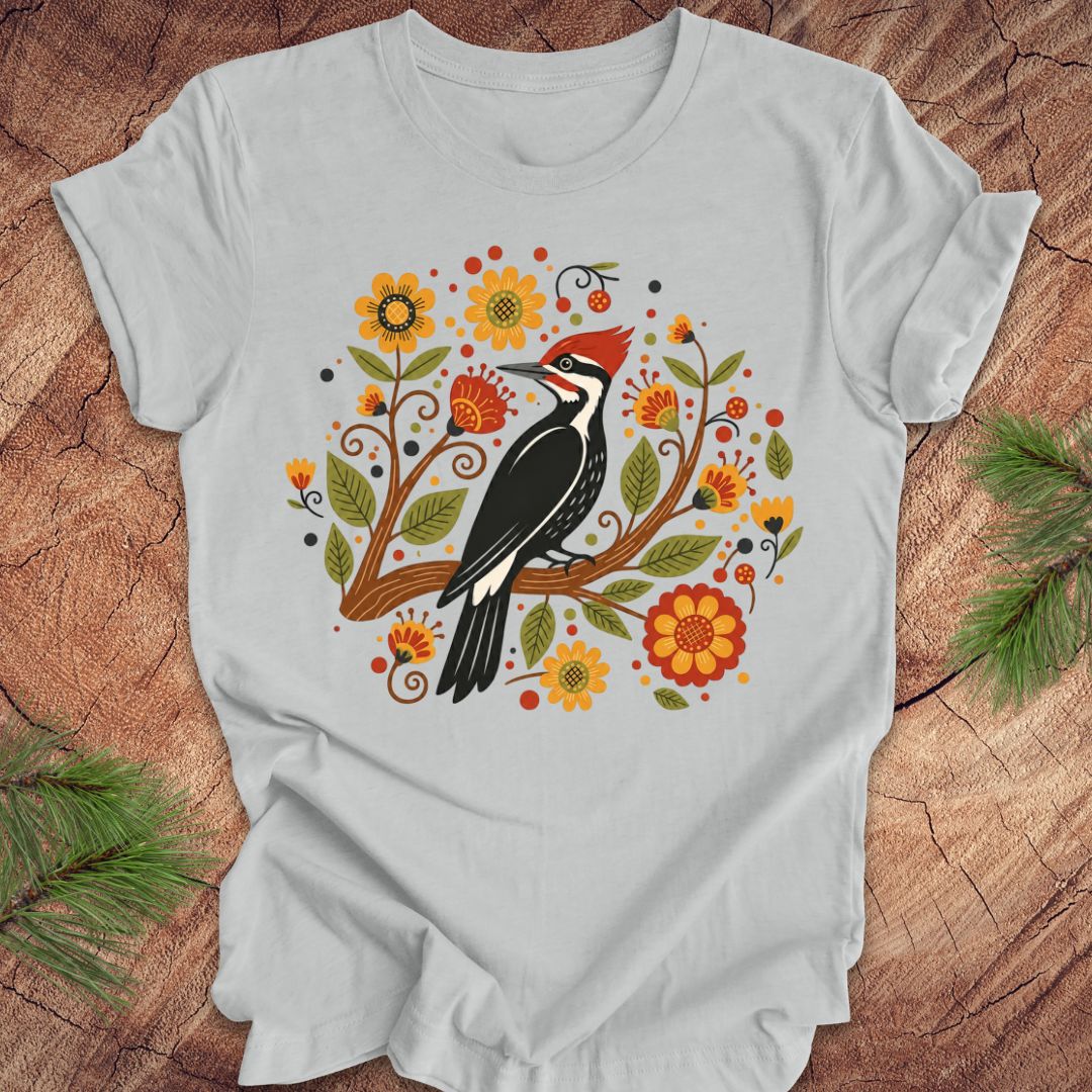 Gray t-shirt with a woodpecker design on a wooden surface