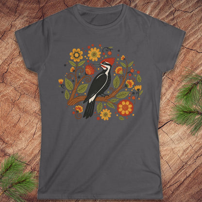 Dark gray t-shirt with a woodpecker and floral design on a wood background.