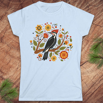 Light blue t-shirt with a woodpecker and floral design on a wood background.