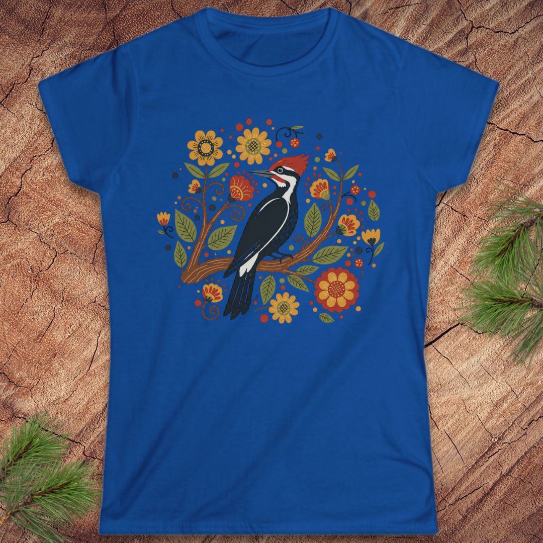 Blue t-shirt with a woodpecker and floral design on a wood background.