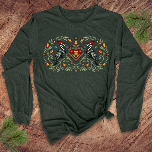 Green long-sleeve shirt with a heart design featuring two birds on a wooden surface.