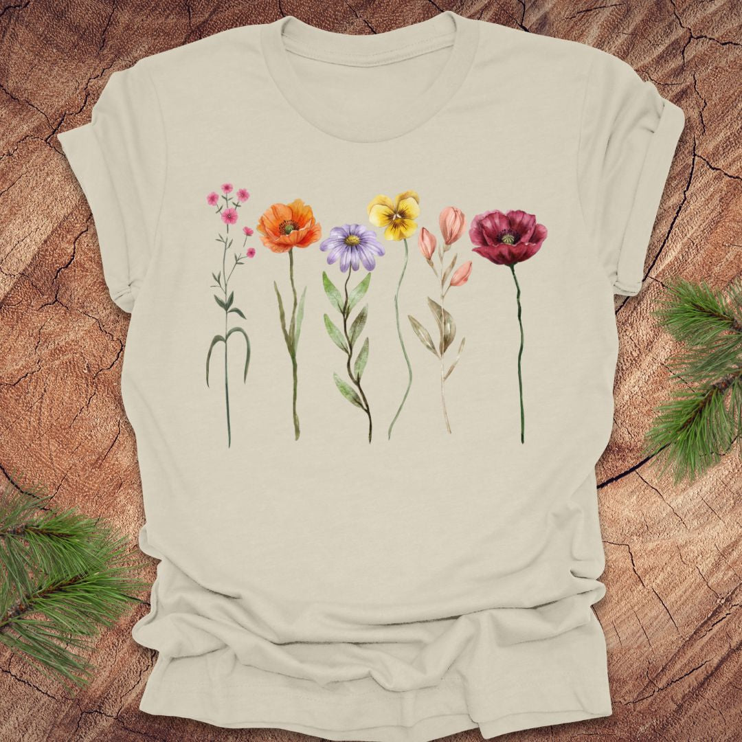 Beige t-shirt with colorful floral designs on a wooden surface