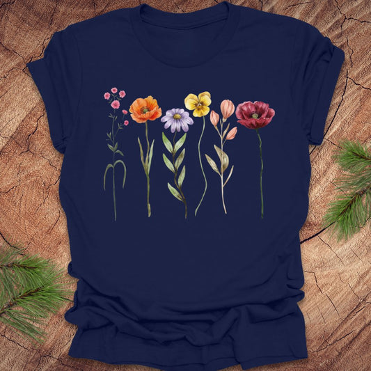 Navy blue t-shirt with colorful floral design on a wooden surface
