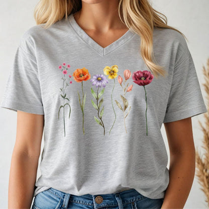 Person wearing a gray t-shirt with colorful floral designs.