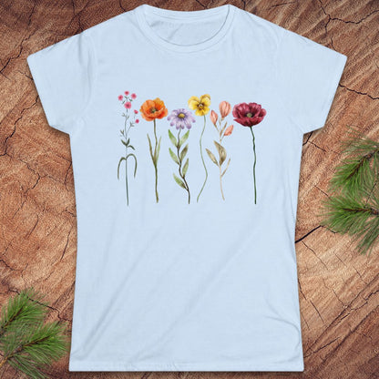 Light blue t-shirt with floral designs on a wooden surface