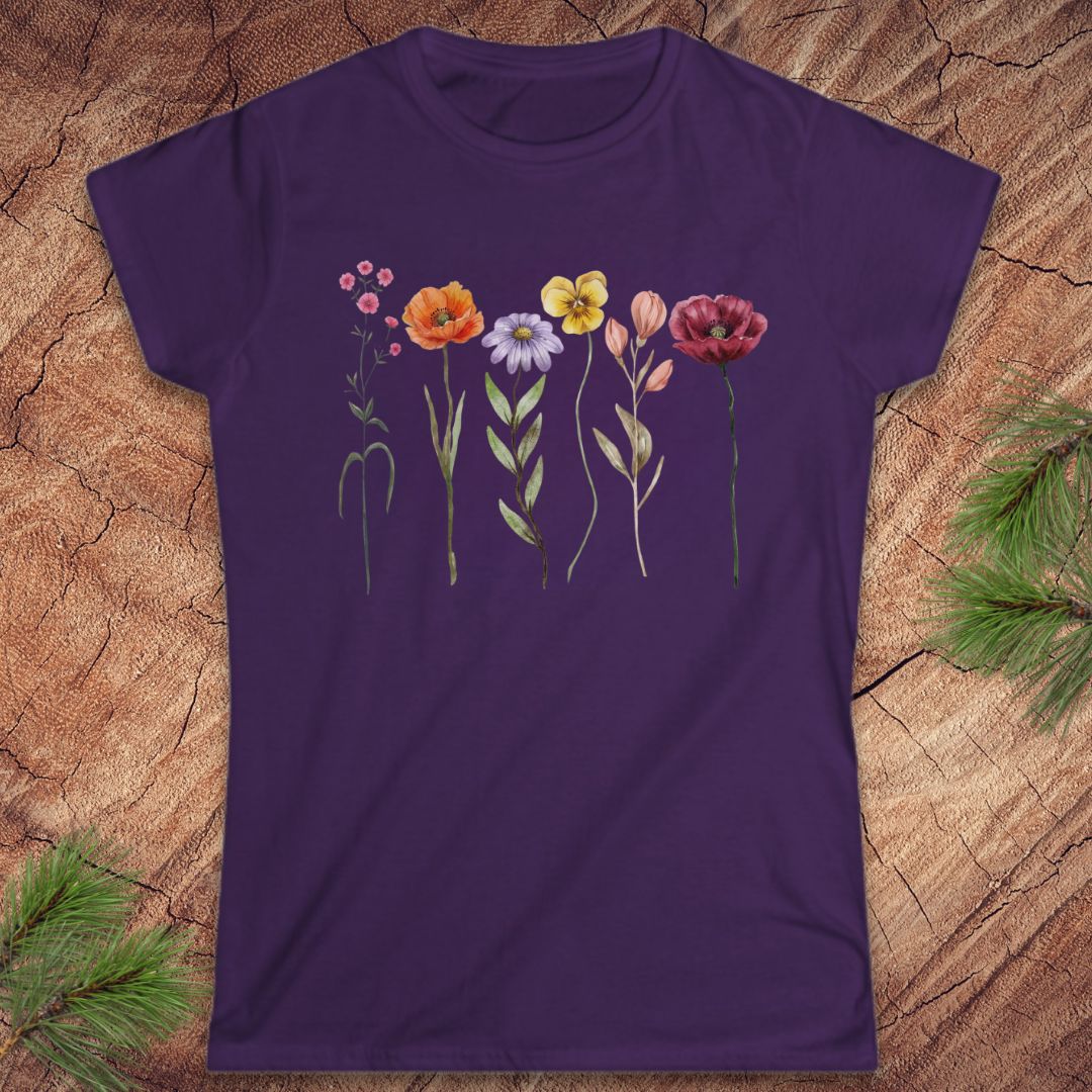Purple t-shirt with floral design on a wooden surface