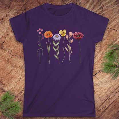 Purple t-shirt with floral design on a wooden surface