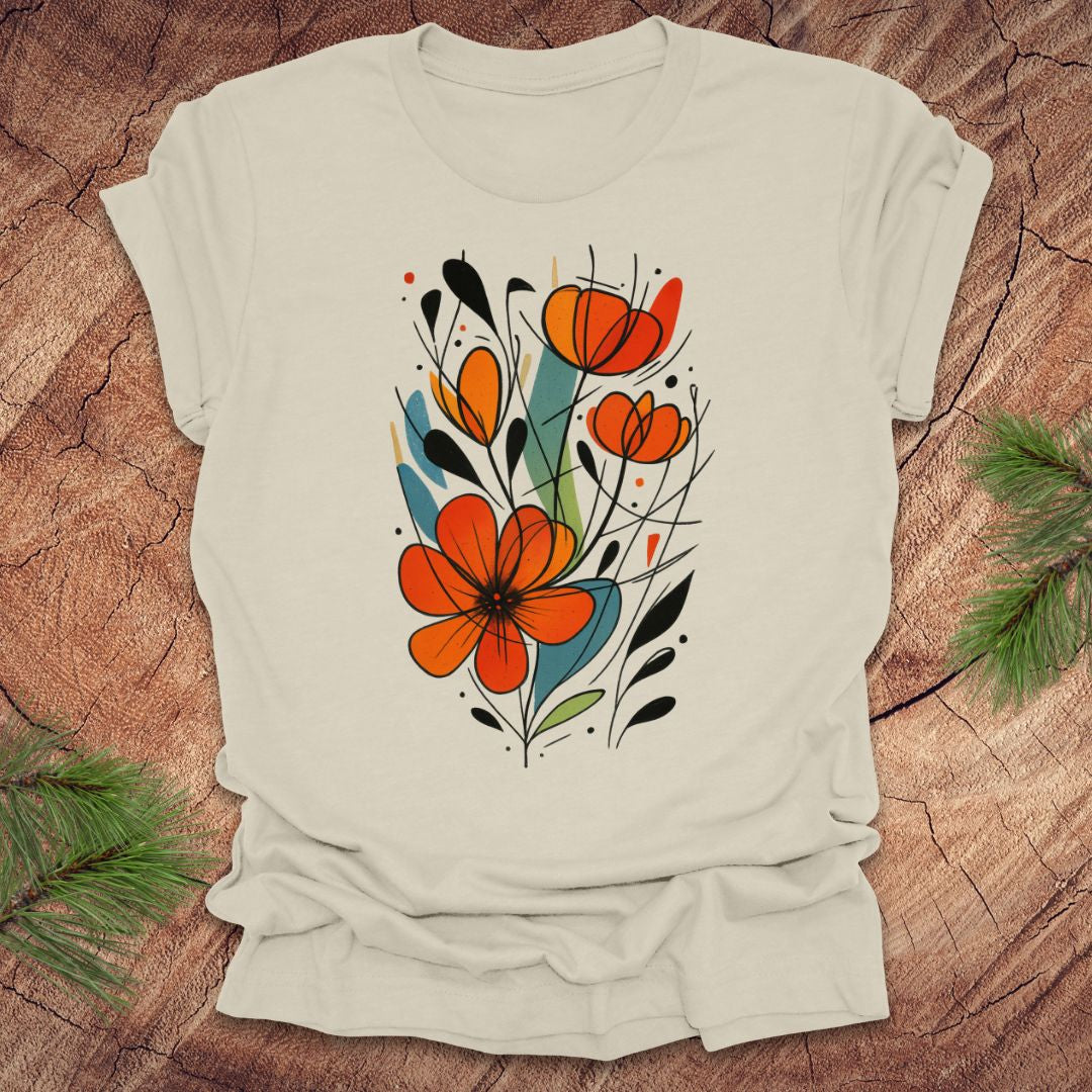 Beige t-shirt with orange floral design on a wooden surface