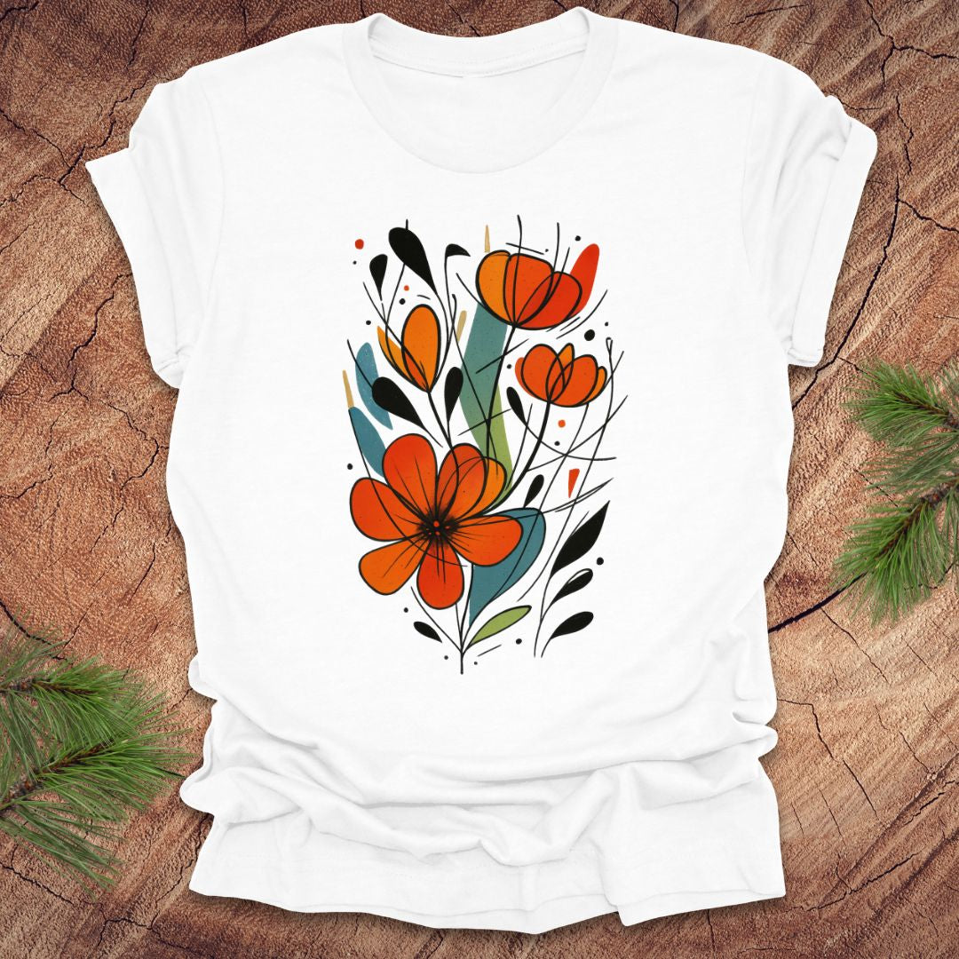 White t-shirt with orange floral design on a wooden surface