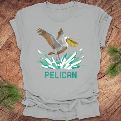 Gray t-shirt with a pelican graphic and 'PELICAN' text on a wooden surface.