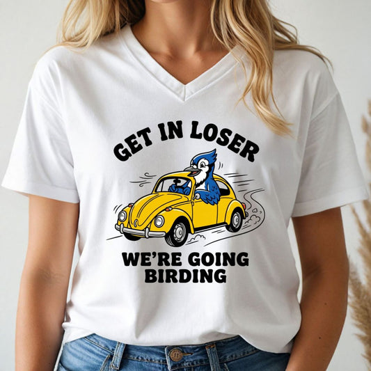 Person wearing a white v-neck t-shirt with a graphic blue jay design and text, 'get in loser. we're going birding' on a white background.