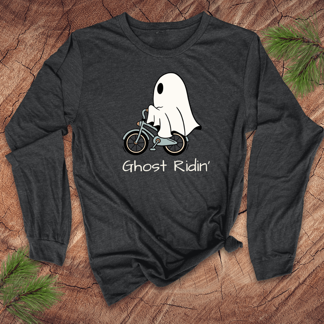 Dark long-sleeve shirt with a ghost riding a bicycle graphic and 'Ghost Ridin'' text on a wooden surface.