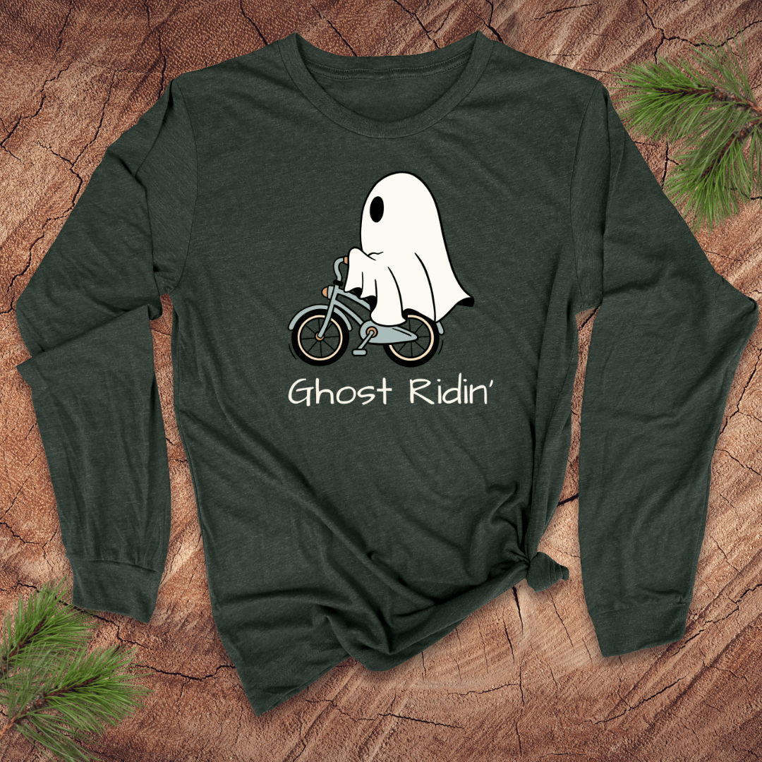 Green long-sleeve shirt with a ghost riding a bicycle graphic and 'Ghost Ridin'' text on a wooden surface.
