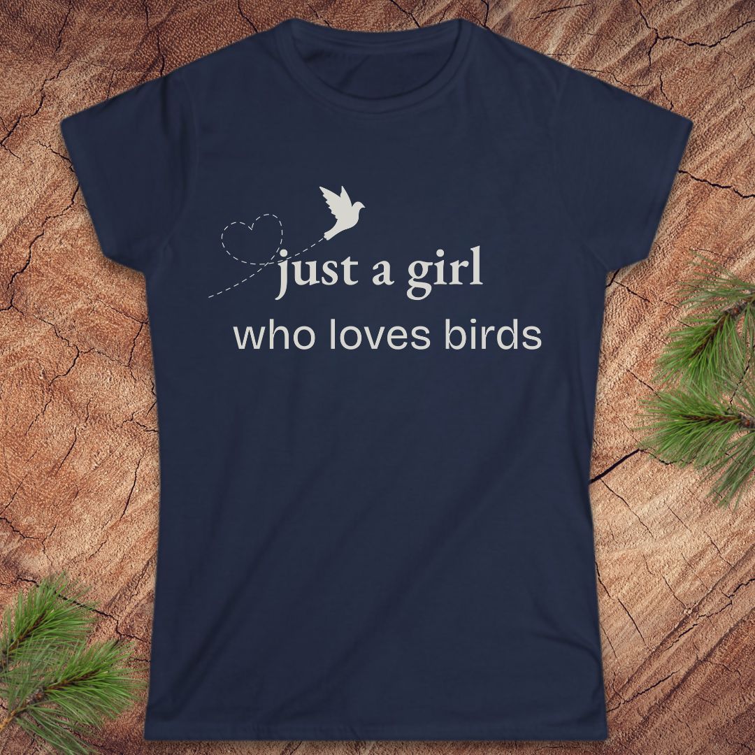 Navy blue t-shirt with a bird and text, 'just a girl who loves birds' on a wood background.