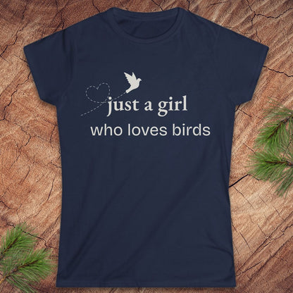 Navy blue t-shirt with a bird and text, 'just a girl who loves birds' on a wood background.