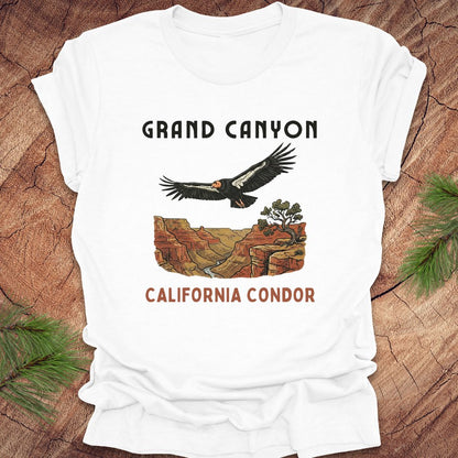 White t-shirt with Grand Canyon and California Condor design on a wooden surface.