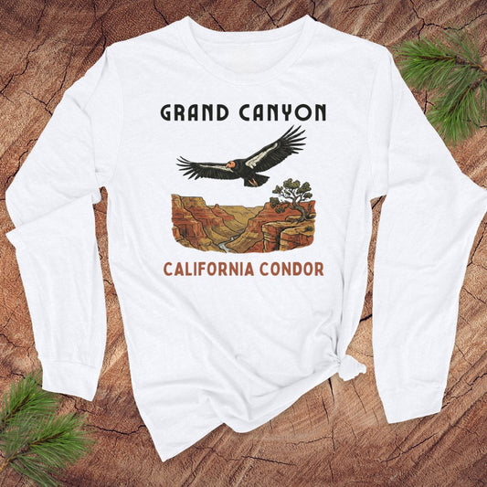 White long-sleeve shirt with Grand Canyon and California Condor design on a wooden surface.