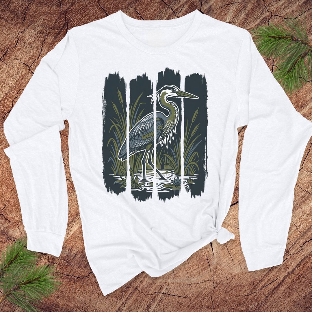 White long-sleeve shirt with a heron design on a wooden surface