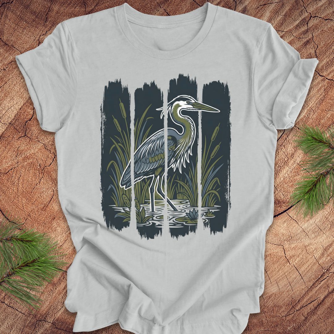 Gray t-shirt with a heron design on a wooden surface