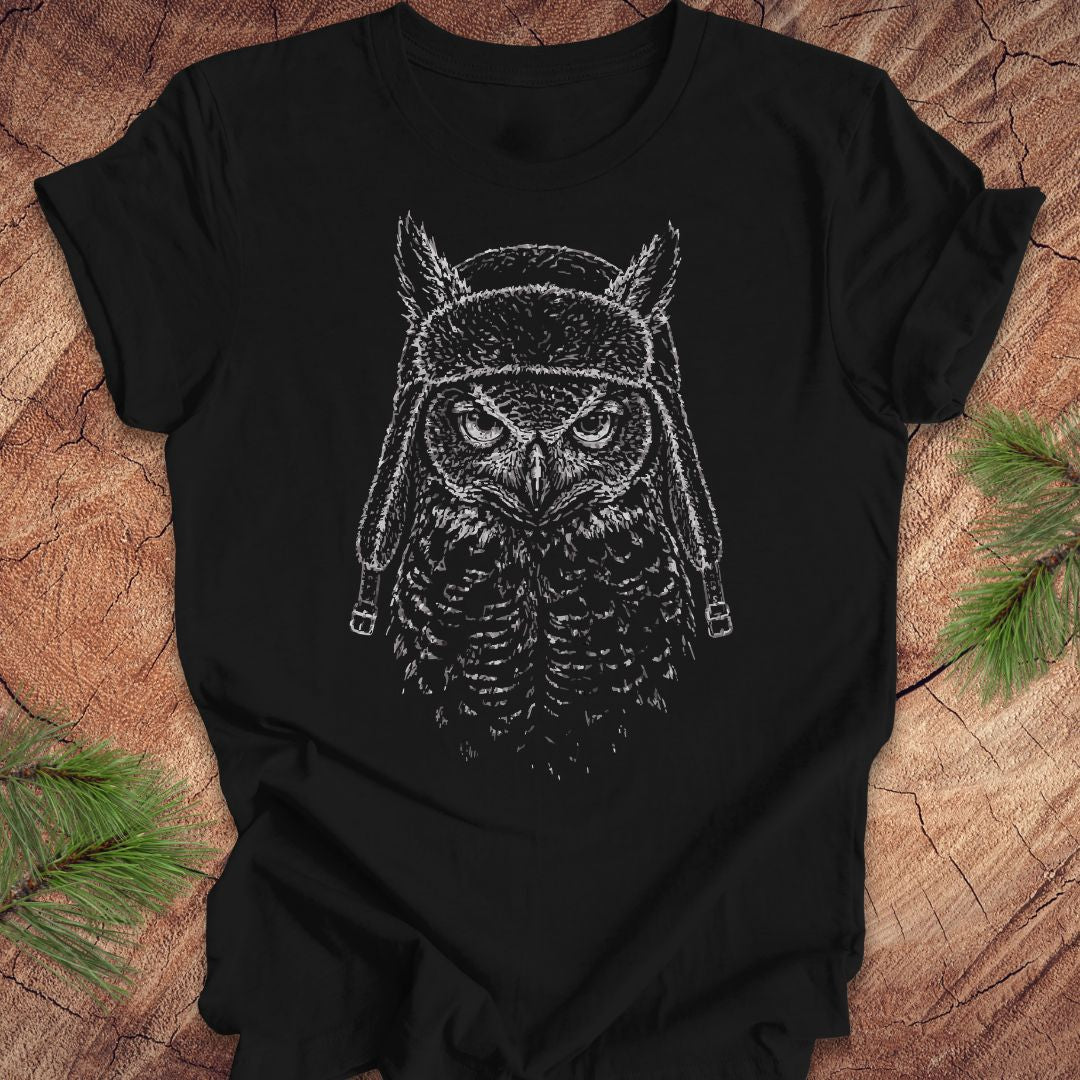 Black t-shirt with an owl graphic design on a wooden surface