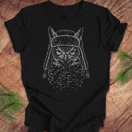 Black t-shirt with an owl graphic design on a wooden surface
