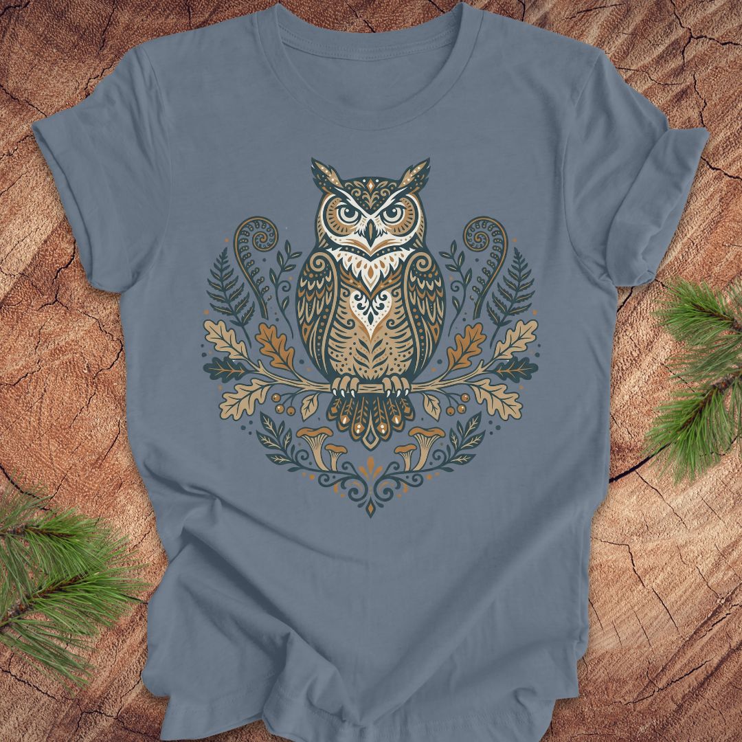 Steel blue t-shirt with an owl and woodland design on a wooden surface