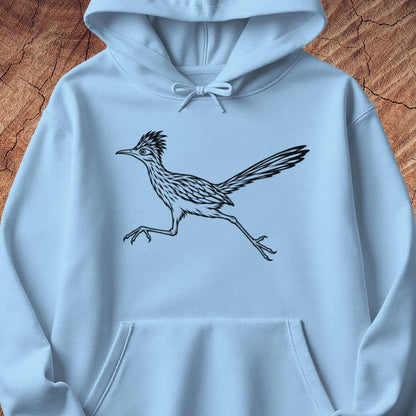 A light blue hoodie laid flat on a textured brown wood background, featuring a black line art graphic of a running roadrunner on the chest.