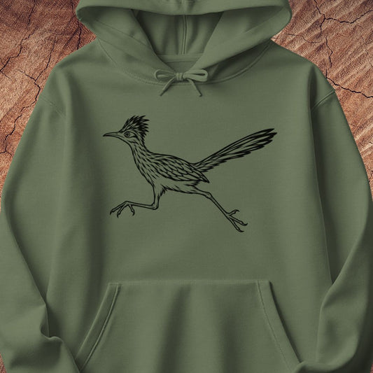 An olive green pullover hoodie featuring a black line art graphic of a running roadrunner bird on the chest, displayed against a textured brown wood background.