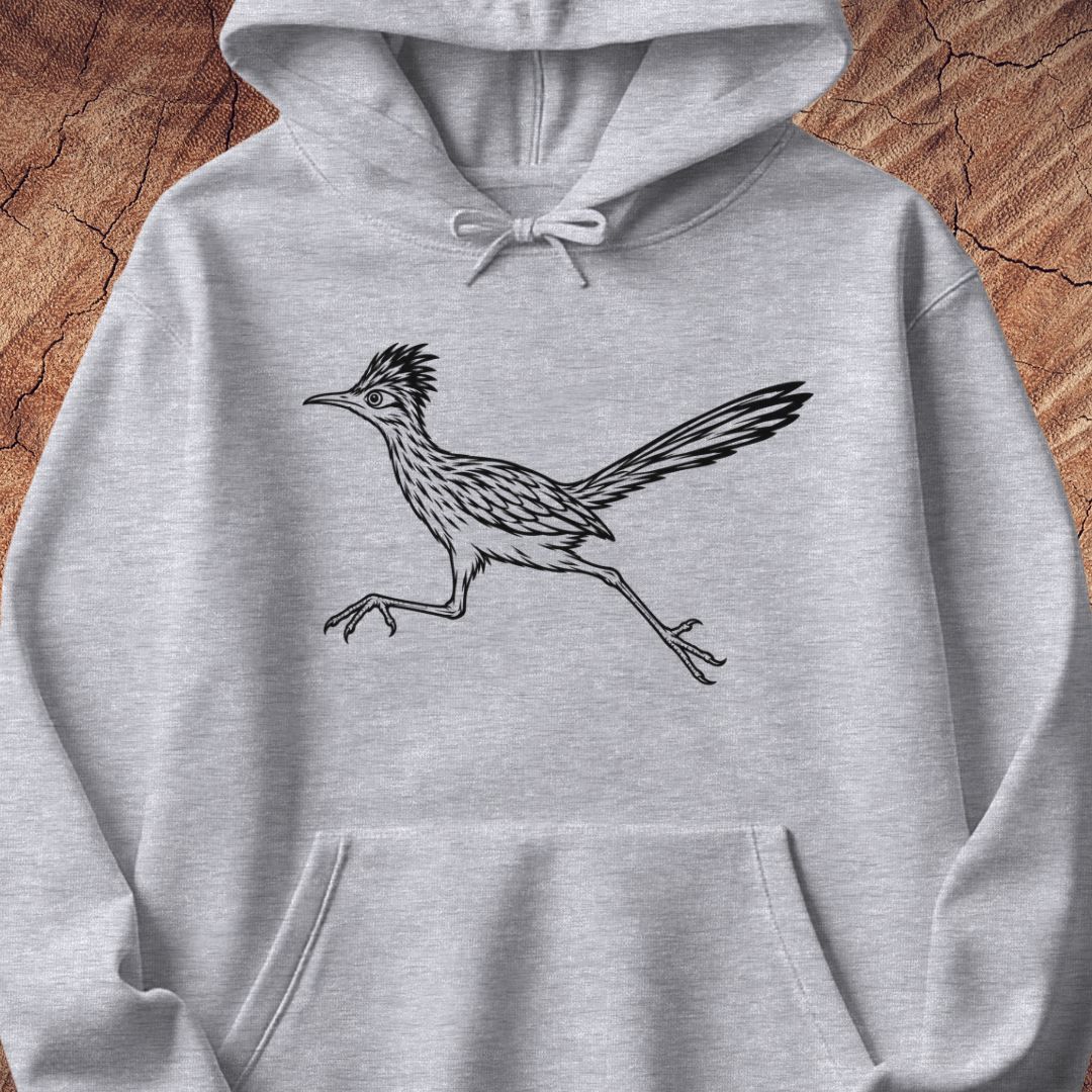 A light heather gray pullover hoodie featuring a black line art illustration of a running roadrunner bird on the chest, displayed flat against a textured wood background.