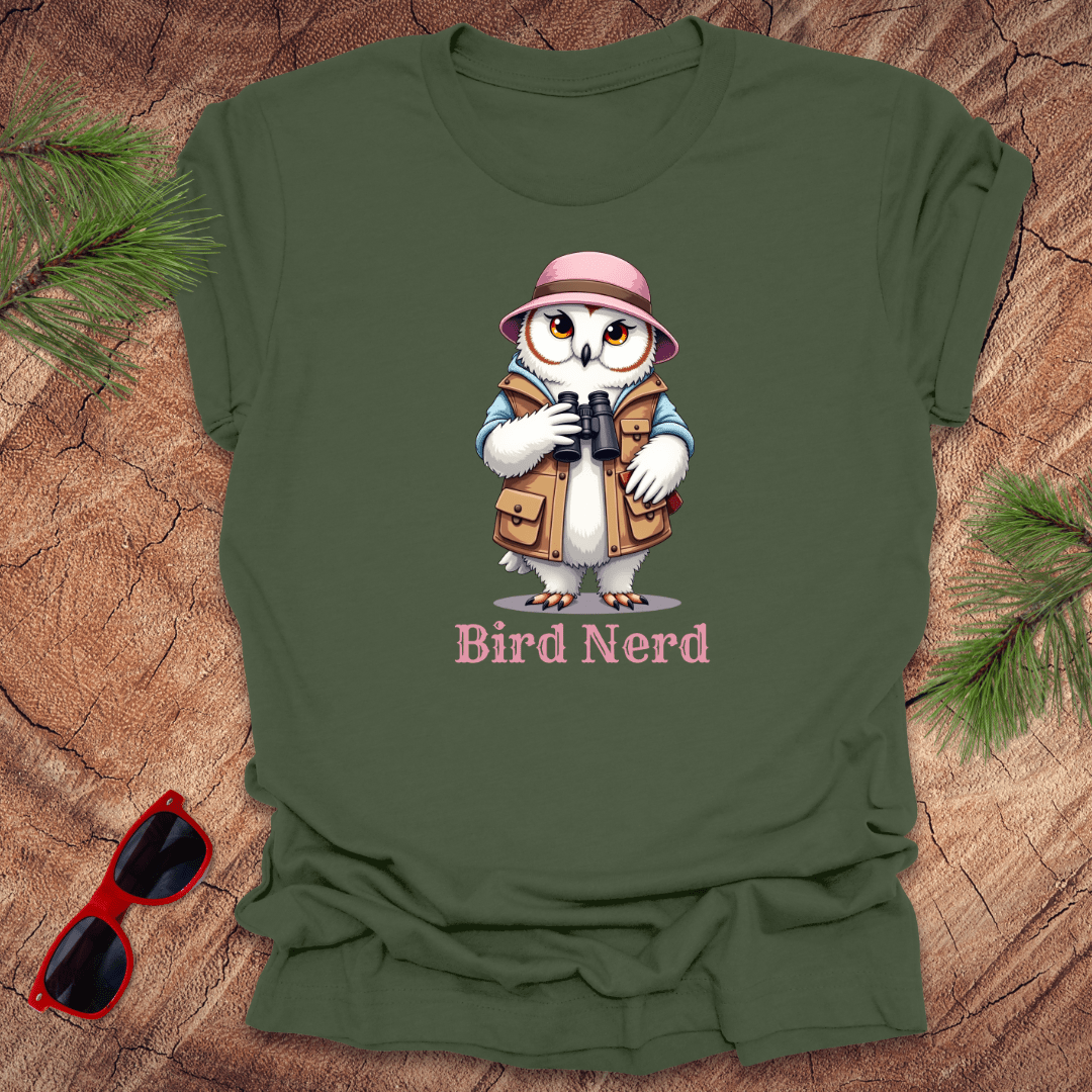 Green t-shirt with an animated snowy owl in birdwatching gear with "bird nerd" text on a wood background.