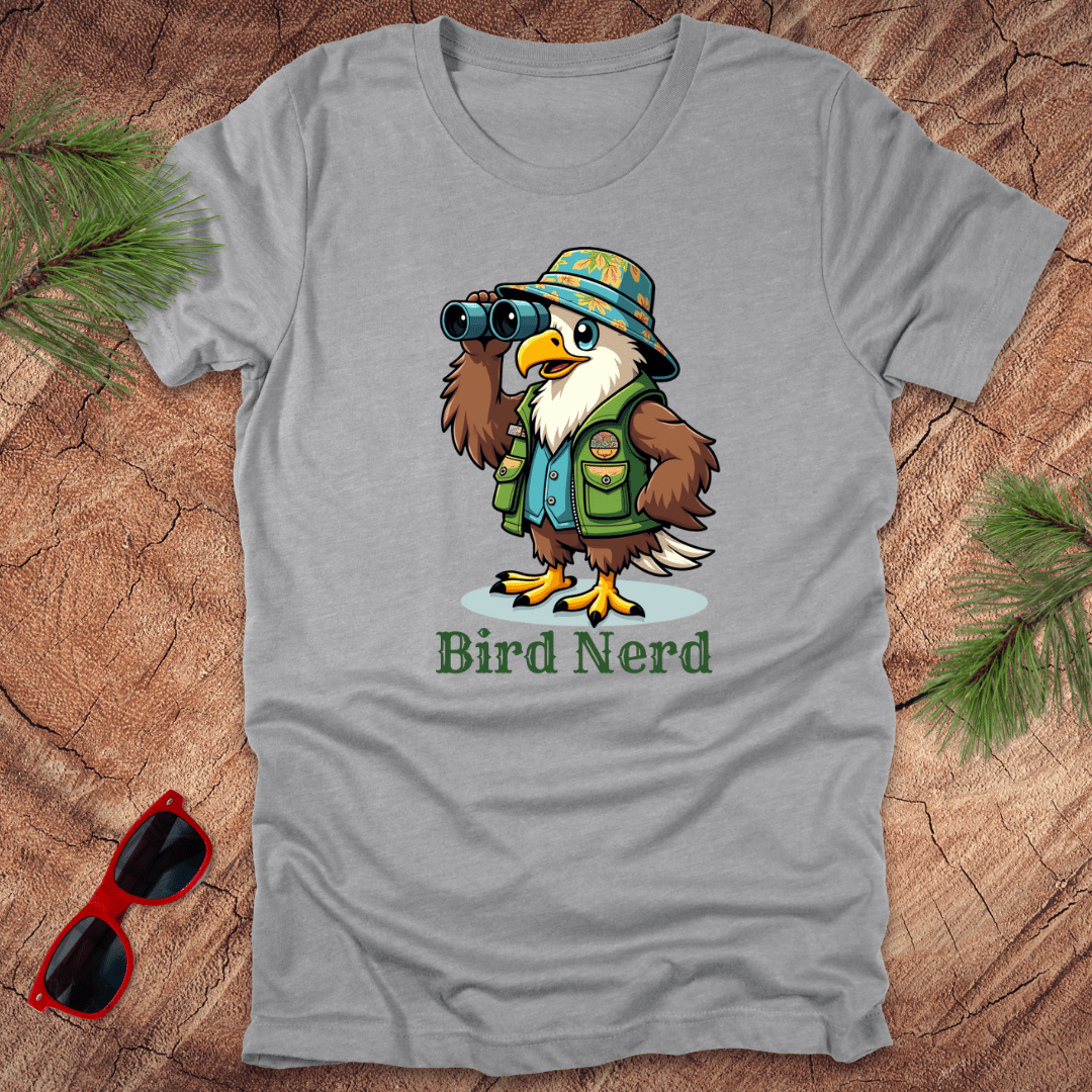 Grey t-shirt with an animated eagle in birdwatching gear with "bird nerd" text on a wood background.