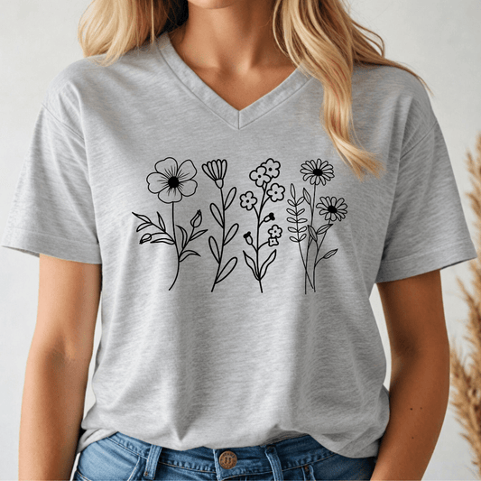 Person wearing a gray t-shirt with black floral designs