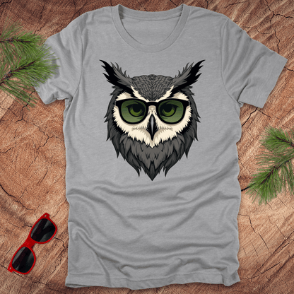Grey tshirt with a graphic of an owl head with sunglasses on. it is on a wood background.